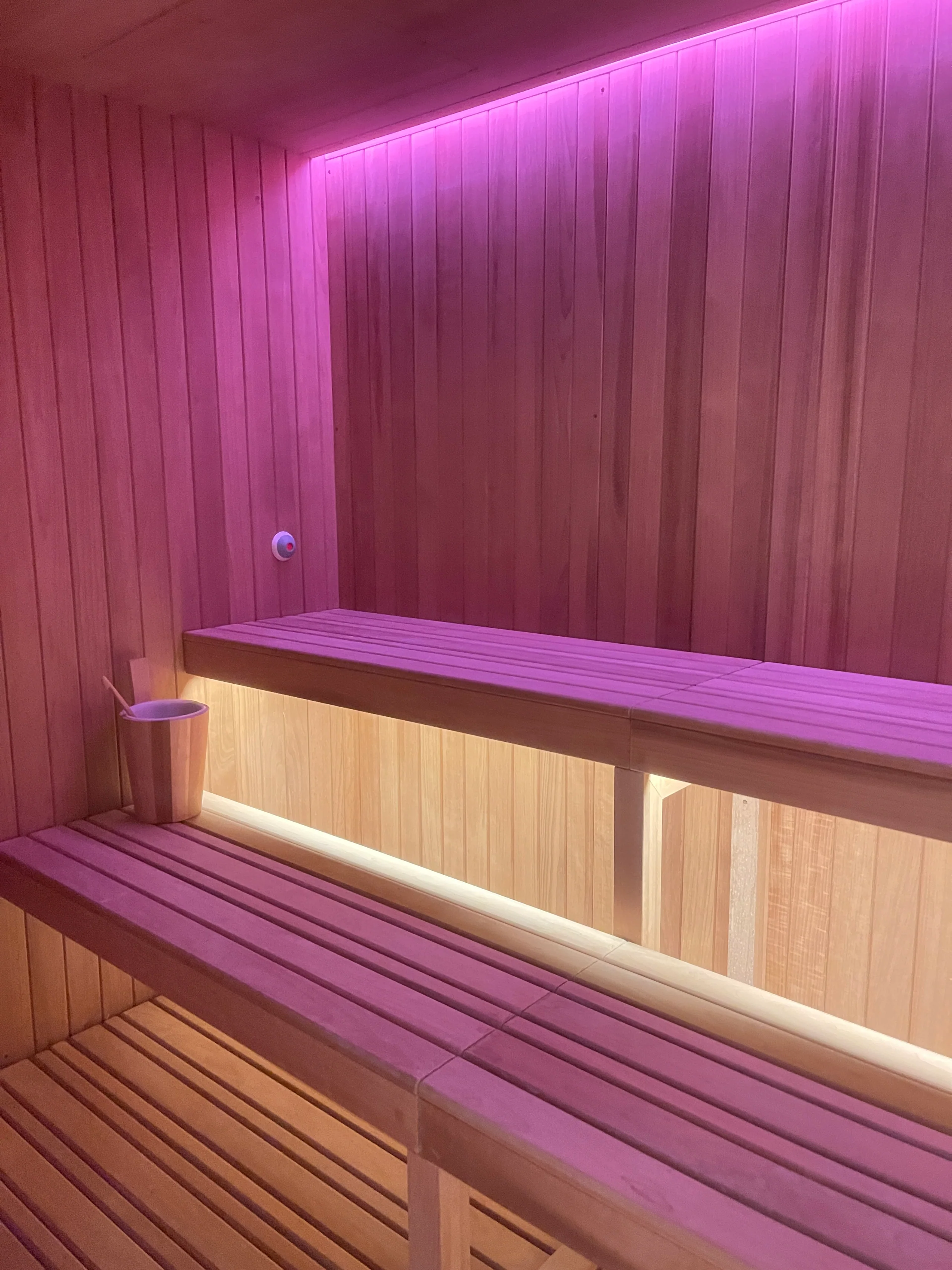 Timber-lined hotel sauna with ambient lighting